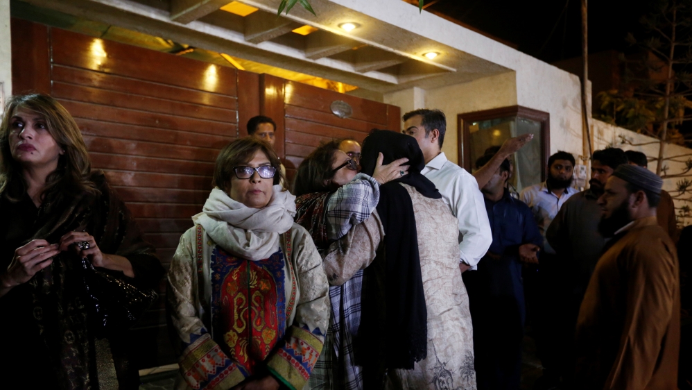 People gather outside the residence of Junaid Jamshed, pop star turned preacher, who was on board the PIA flight [Reuters]
