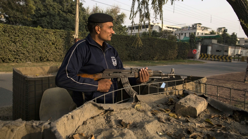 A police officer stands guard outside the Batul Noor mosque of the Ahmadi community in Lahore