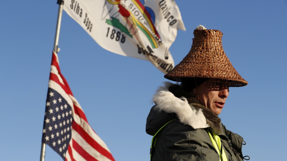 Activist Hugh Ahnatock of the Inupiaq tribe pauses after singing while the sun rises inside of the Oceti Sakowin camp as demonstrations continue against plans to pass the Dakota Access pipeline