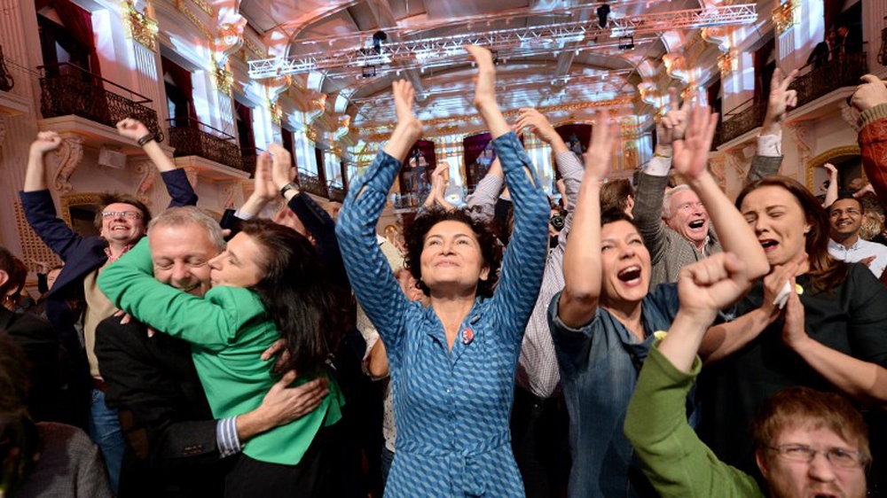 Alexander Van der Bellen supporters react to the first results after the presidential election [AFP]