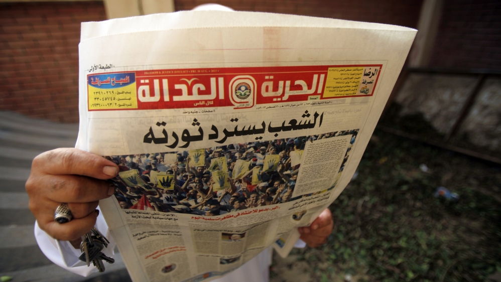 Egyptian man reading newspaper