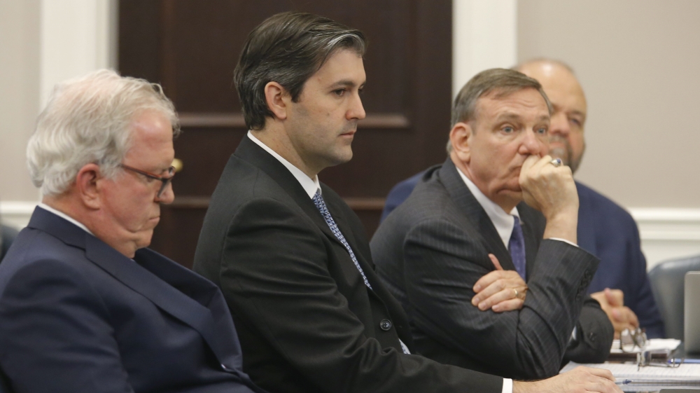 Former North Charleston police officer Michael Slager sits with his defense team at the Charleston County court in Charleston