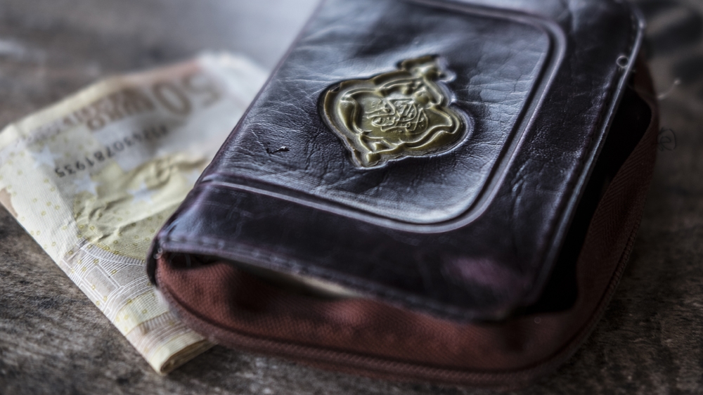 A Quran and 400 euros were found on the body of Ghalia Abdi. The day after the washing and burial, Shadia Abdi went to the local police station and port police to retrieve the personal effects found on the bodies of her sister, niece and nephew. 'I feel like even now, I don't believe this happened. I washed my sister, I buried them, but even now it's like a dream. I feel they are still alive. Maybe I need time to realise I won't have calls or messages from my sister any more,' said Abdi as we sat in the Mytilini police station. July 2016. [Fahrinisa Oswald/Al Jazeera]