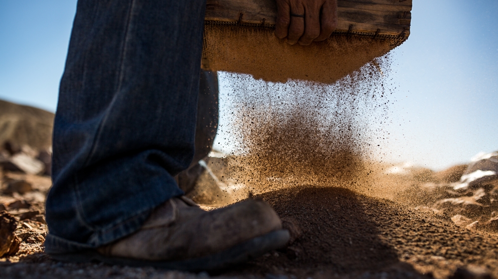 South Africa's artisanal miners spend their days searching for diamonds in the vast landscape while evading capture by private security guards or the police [ Shaun Swingler/Al Jazeera ]