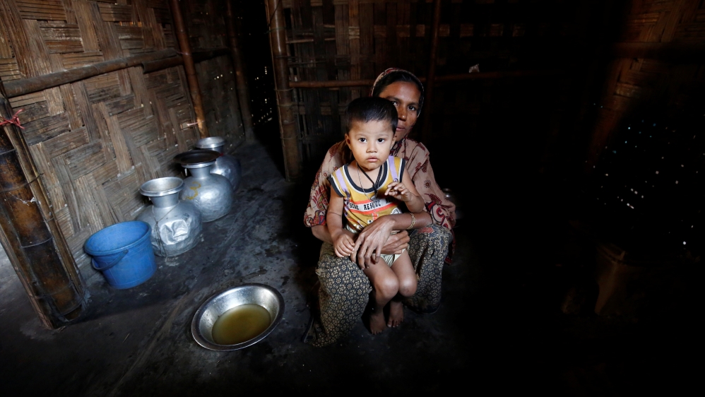A Rohingya Muslim woman poses for a photograph with her son at the Leda unregistered Rohingya Refugee Camp in Teknaf near Cox’s Bazar