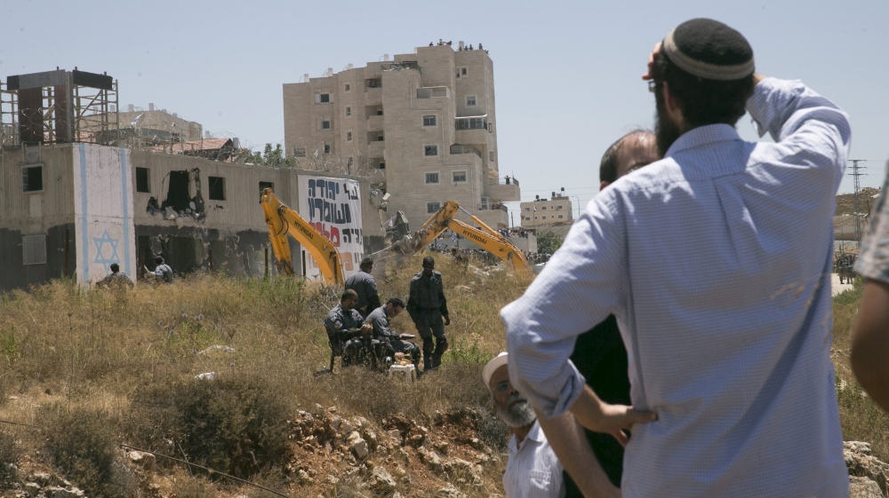 Jewish settlers watch demolition near Ramallah