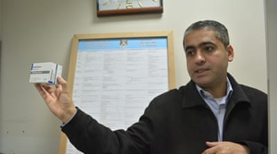 Talha Ahmad, a chemotherapy pharmacist, points to a shortage of medications in Gaza [Mersiha Gadzo/Al Jazeera]