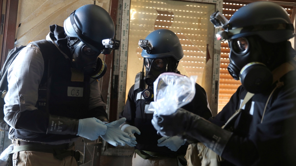 FILE PHOTO: A file photo shows a U.N. chemical weapons expert holding a plastic bag containing samples from one of the sites of an alleged chemical weapons attack in Ain Tarma