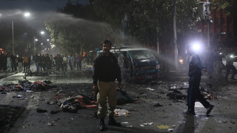 A policeman stands guard at the scene after a blast in Lahore