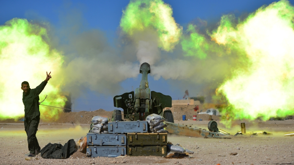 Popular Mobilization Forces (PMF) fires towards Islamic State militants during a battle with Islamic State militants, west of Mosul