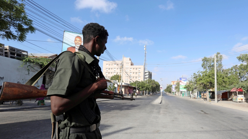 A Somali policeman stands guard along a road which was blocked to control motor vehicle traffic, during a security lock down in Mogadishu