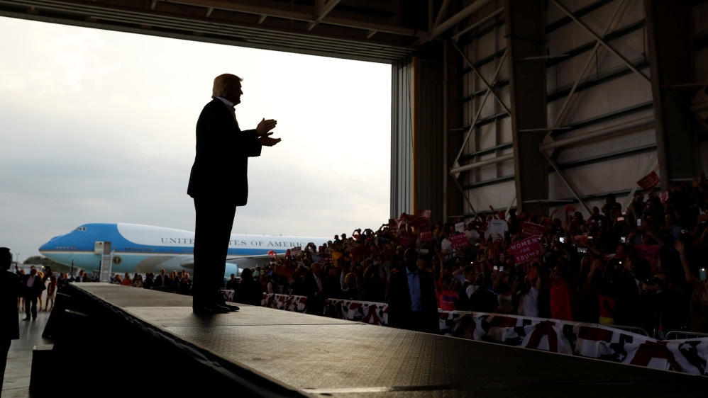 U.S. President Donald Trump applauds his crowd as he holds a "Make America Great Again" rally at Orlando Melbourne International Airport in Melbourne, Florida