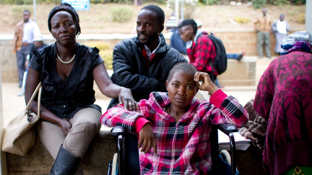 Outside Kijabe Hospital, north of Nairobi, Mwende Mutambuki, left, waits with her brother and her sister-in-law Dorcas Kiteng’e to learn whether doctors will perform surgery to remove Kiteng’e’s ovarian tumours. Since public sector doctors went on strike in December, Kenyans have overwhelmed private hospitals, leading to long waiting times for procedures. [Jacob Kushner/Al Jazeera]