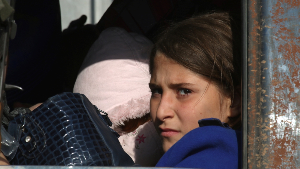 A girl who fled areas of conflict rides a vehicle in Dahiyet al-Assad, west Aleppo city