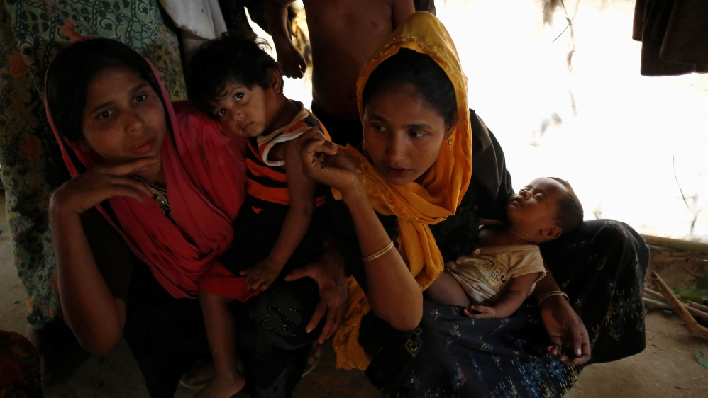 Rohingya refugee women sit inside their house with their child at Balukhali Makeshift Refugee Camp