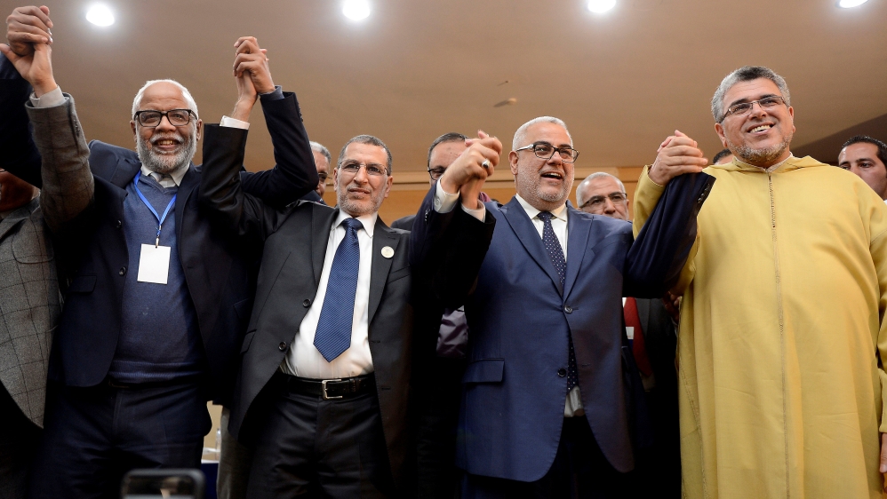 Saad Eddine El Othmani of the Islamist Justice and Development Party (PJD) second left selebrates his first speech during a meeting of PJD at the Moulay Rachid Complex in Rabat