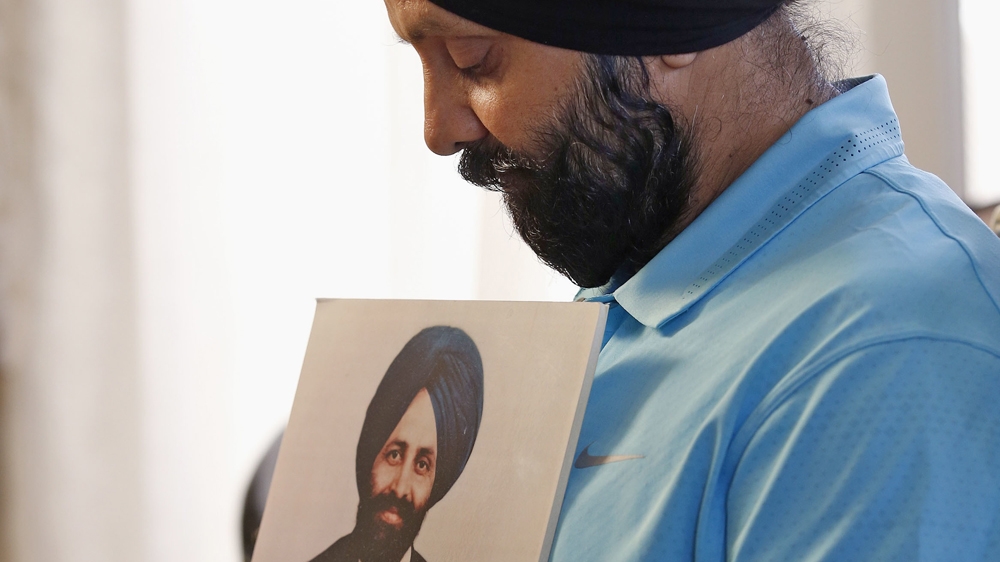 Rana Singh Sodhi holds a photograph of his murdered brother, Balbir Singh Sodhi [File: Ross D. Franklin/AP]