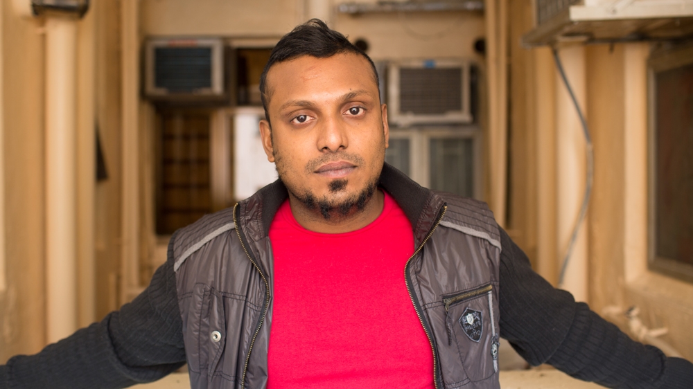 Kellapatha reflects on his family's desolate state in the corridor of his housing block [Maria de la Guardia/Al Jazeera] 