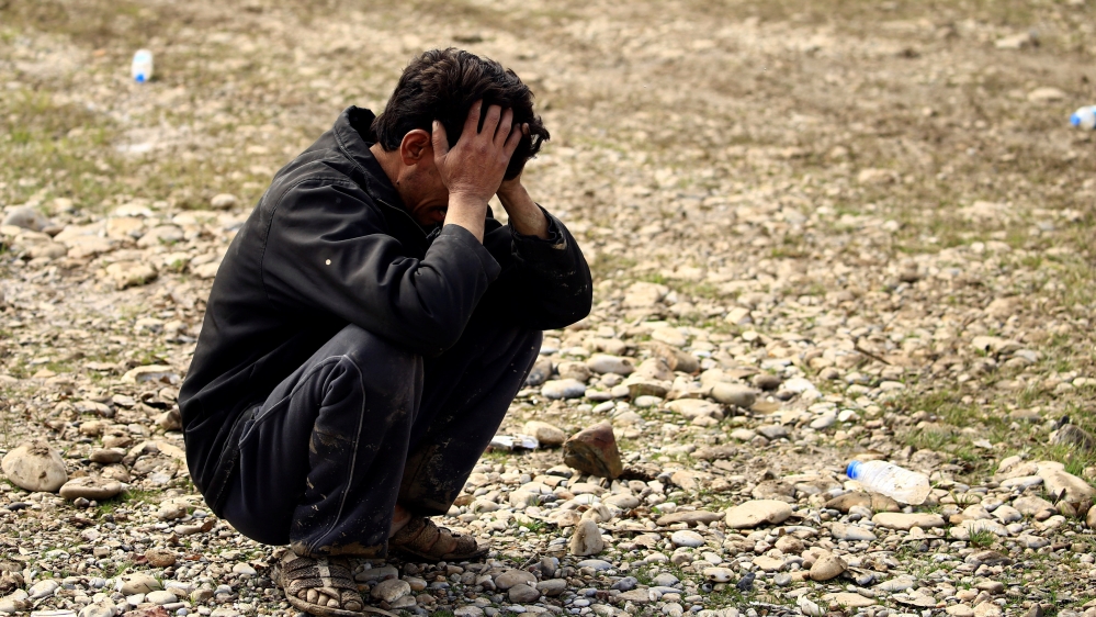 A father reacts after his son was killed in an airstrike, during a battle between Iraqi forces and Islamic State militants, in Mosul, Iraq