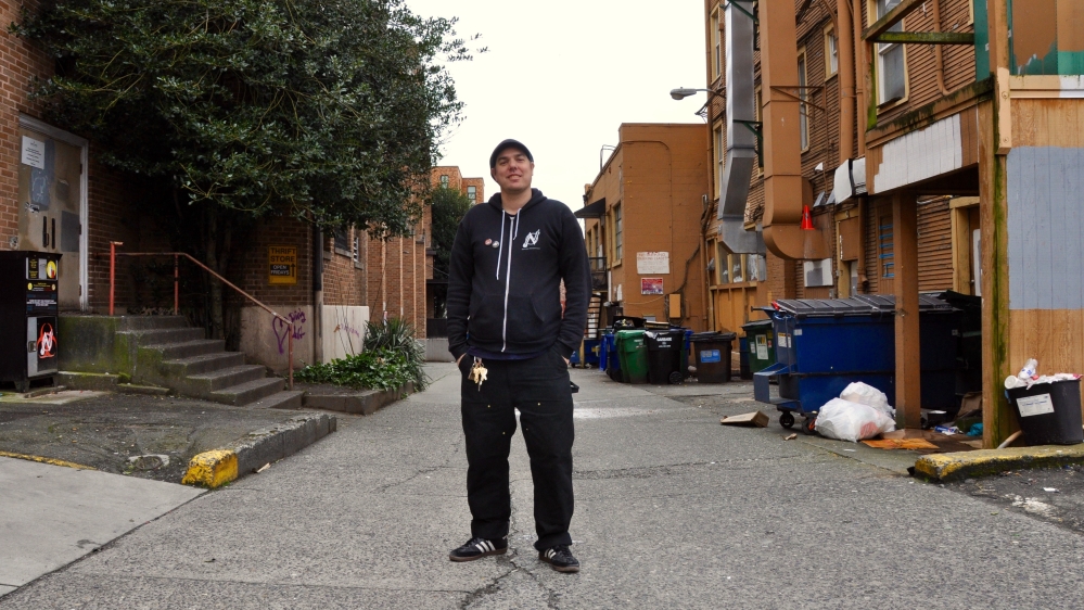 Murphy stands in a back alley in Seattle's University District where he runs a needle exchange [Emily Mulder/Al Jazeera]