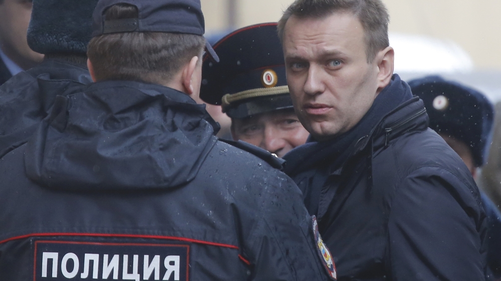 Russian opposition leader Alexei Navalny is escorted upon his arrival for a hearing after being detained at a protest against corruption [Reuters/Maxim Shemetov]