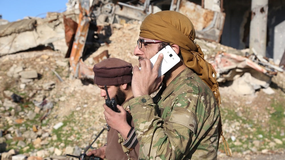 A Syrian rebel commander speaks with a Russian representative during the evacuation process [Malek Al Shimale/Al Jazeera]