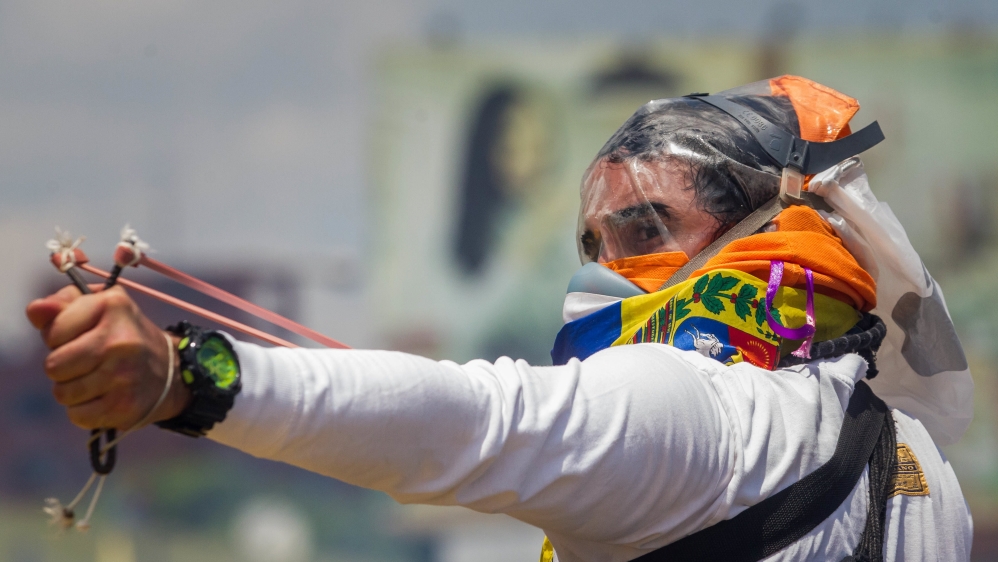 Demonstrators and police clash in opposition protests in Caracas