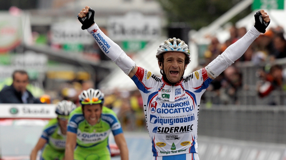 FILE PHOTO: Androni-Diquigiova team rider Scarponi celebrates winning the 19th stage of the Giro d''Italia cycling race