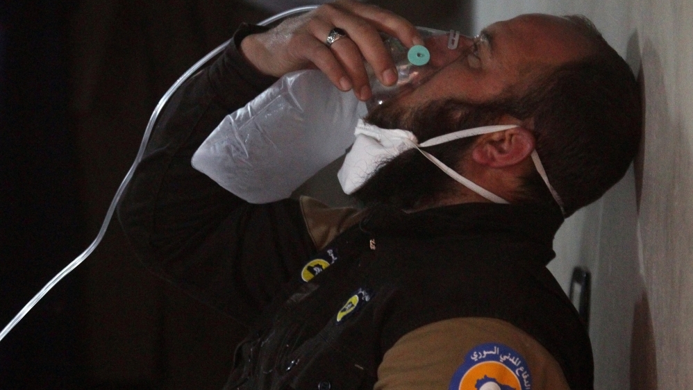 A civil defense member breathes through an oxygen mask, after what rescue workers described as a suspected gas attack in the town of Khan Sheikhoun in rebel-held Idlib
