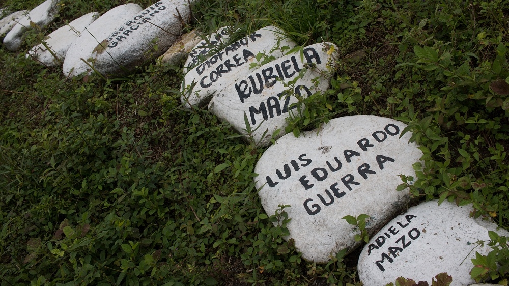 Stones with the names of those murdered by armed groups [Joe Parkin Daniels/Al Jazeera]