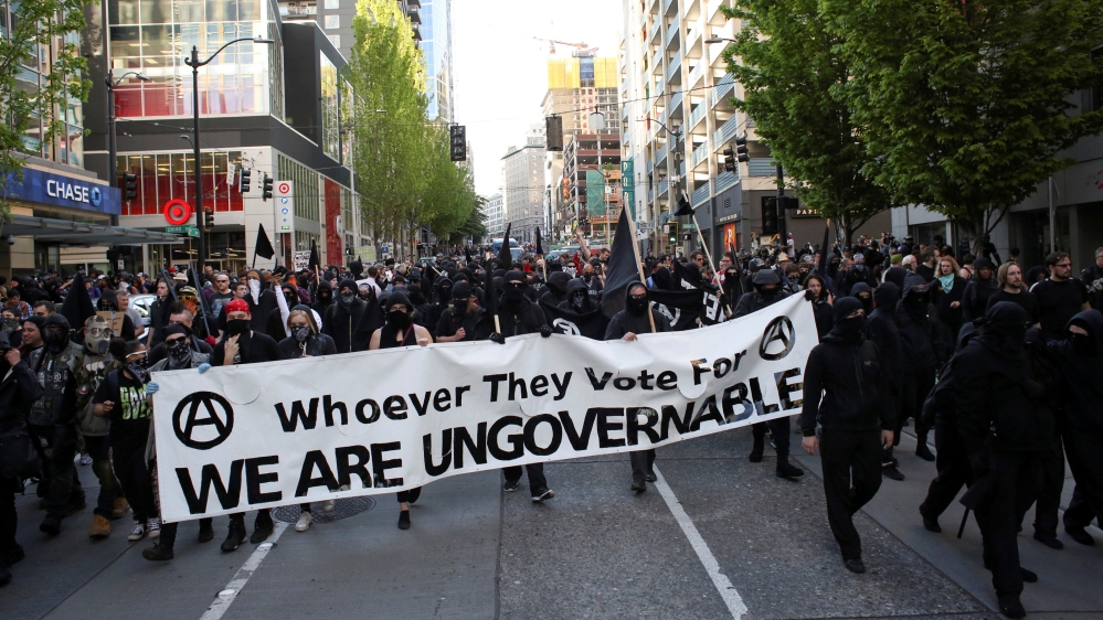 Protesters march through downtown during anti-capitalist protests following May Day marches in Seattle
