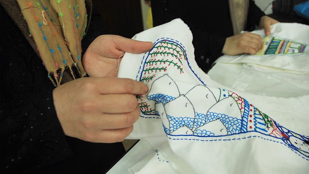 
The hands that make these dolls are no strangers to the suffering of Syrian families [Courtesy of the Ana Collection/Al Jazeera]
