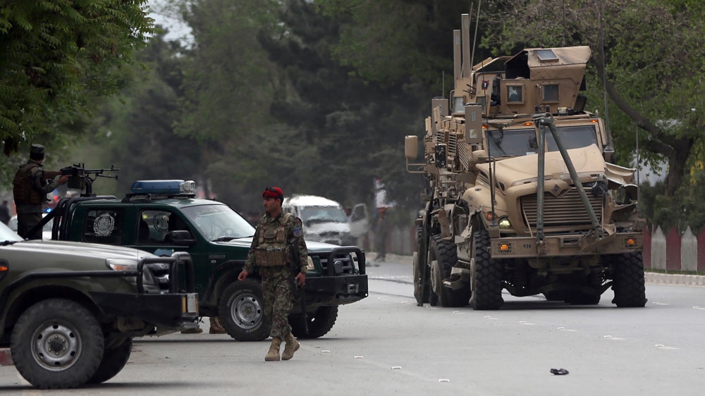 A damaged military vehicle was being pulled near the site of the attack in Kabul [Massoud Hossaini/AP]