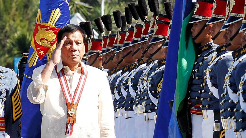 Philippine President Rodrigo Duterte salutes during arrival honours at the Philippine Military Academy in Baguio