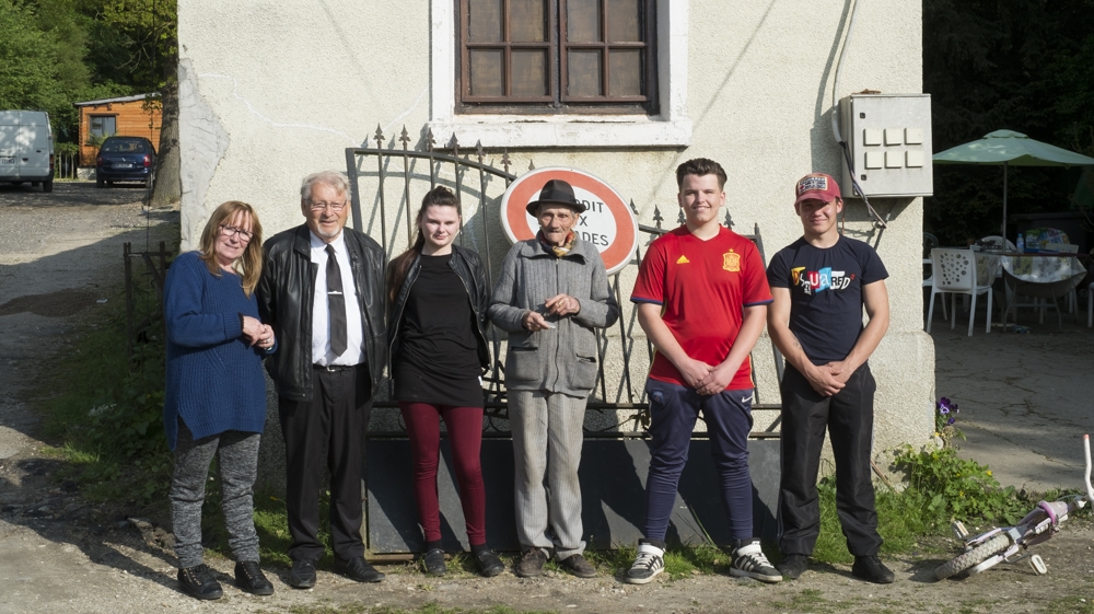 Gureme with some of his family members at his home in Saint-Germain-les-Arpajon [Raymond Bobar/Al Jazeera]