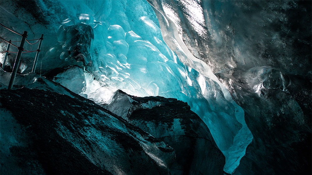 Ice caves form inside glaciers, giving visitors a unique perspective of Falljokull's inner structure. Guides say the ice caves never survive the summer months [Alexander Lerche/Al Jazeera]
