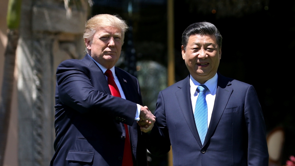 U.S. President Trump and China''s President Xi shake hands during walk at the Mar-a-Lago estate after a bilateral meeting in Palm Beach