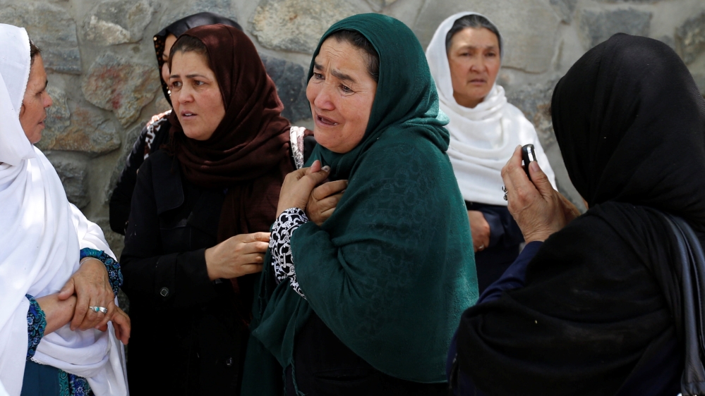 Women mourn outside a hospital in Kabul after the blast [Mohammad Ismail/Reuters]