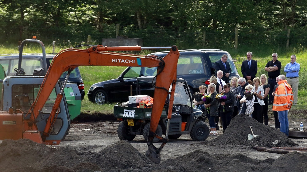 The families of Disappeared victims Seamus Wright and Kevin McKee take part in a ceremony at the spot where human remains were found [Cathal McNaughton/Reuters]