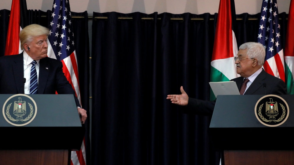 Abbas extends his hand to Trump during their remarks after their meeting at the Presidential Palace in the West Bank city of Bethlehem
