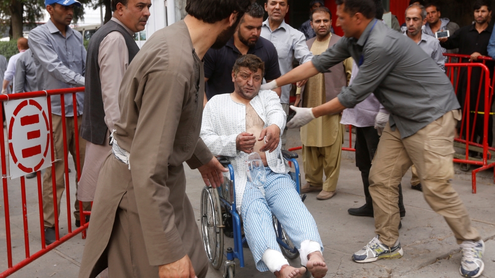 An injured man leaves a hospital after he received treatment, after a blast in Kabul