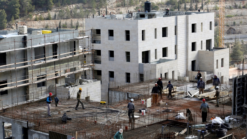 Labourers work at a construction site in the Israeli settlement of Ramot in an area of the occupied West Bank that Israel annexed to Jerusalem