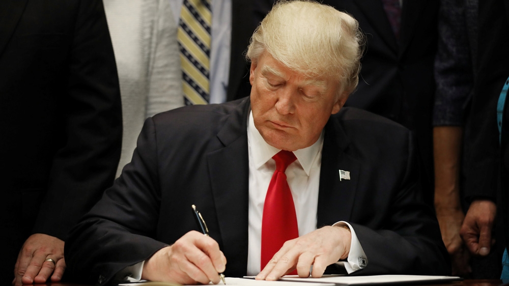 President Donald Trump signs an executive order on education