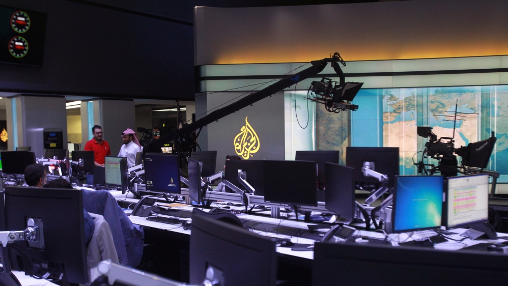 Staff work inside Al Jazeera Media Network HQ in Doha