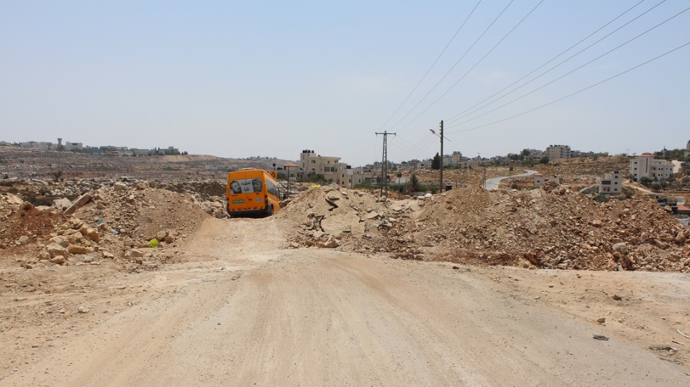 Villagers have built a dirt track through a roadblock created by the Israeli military on the southeastern edge of Kobar [Nigel Wilson/Al Jazeera]