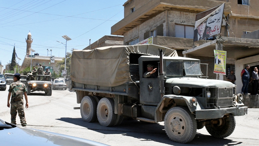 A convoy of Lebanese army soldiers drives at the entrance of the border town of Arsal, in eastern Bekaa Valley