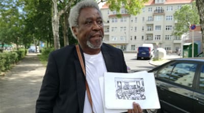 
Tanzanian-born campaigner Mnyaka Sururu Mboro recalls the personal stories of how the German empire affected his family [Gouri Sharma/Al Jazeera] 