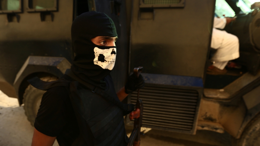 A member of Saudi Special Forces holds his weapon as he walks in Awamiya [Faisal Al Nasser/Reuters]