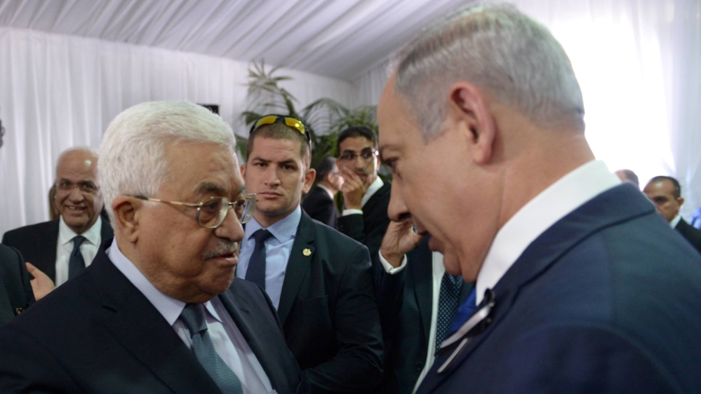 Israeli PM Netanyahu shakes hands with Palestinian President Abbas during funeral of former Israeli President Shimon Peres in Jerusalem