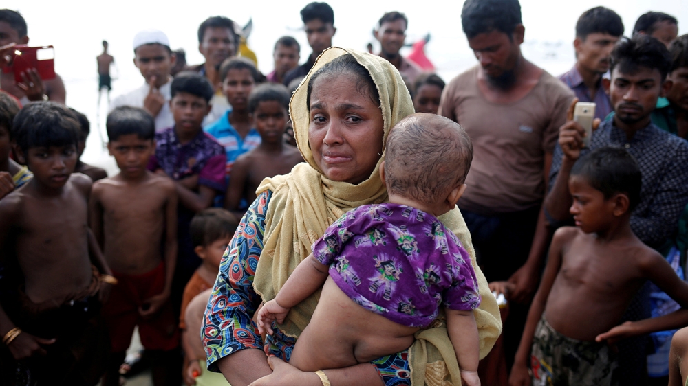 A Rohingya refugee woman cries after crossing the Bangladesh-Myanmar border